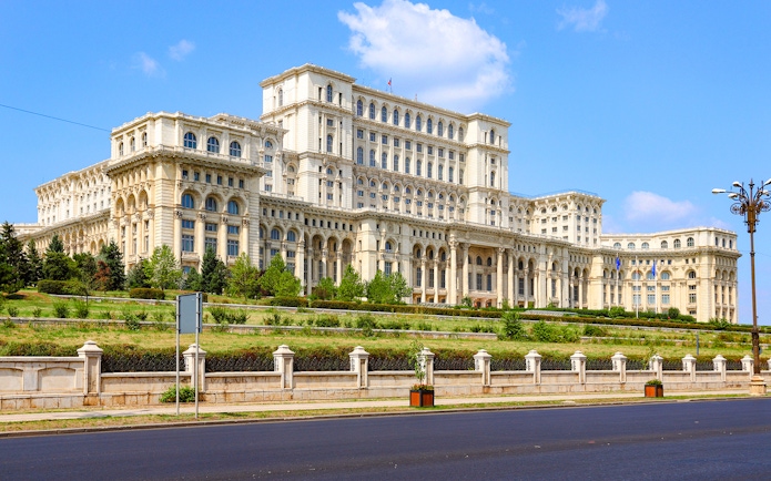 Bucharest Palace of the Parliament exterior with clear blue sky.