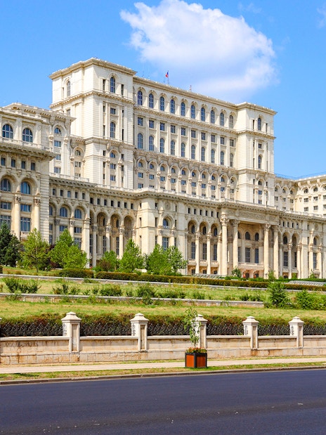 Bucharest Palace of the Parliament exterior with clear blue sky.