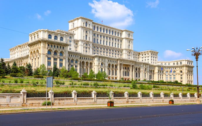 Bucharest Palace of the Parliament exterior with clear blue sky.