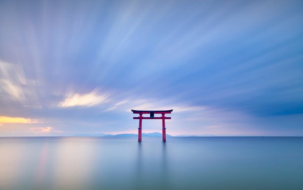 Torii gate in Lake Biwa at sunset, Shiga Prefecture, Japan.