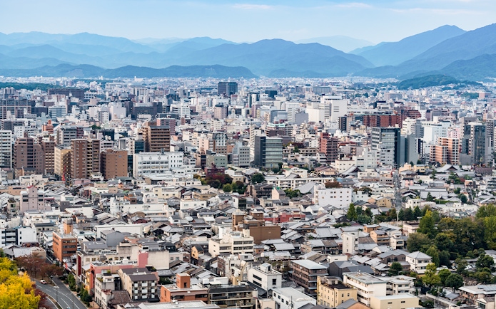 Kyoto cityscape with distant mountains viewed from Kyoto Tower.
