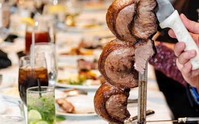 Skewered meat being served at a Brazilian steakhouse in Rio de Janeiro.