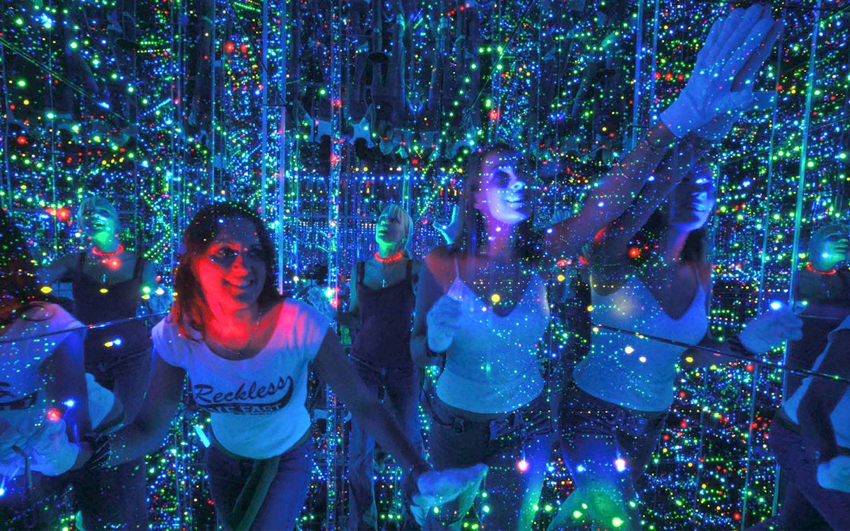 Visitors exploring the mirrored light maze at Infinity Attraction, Gold Coast.