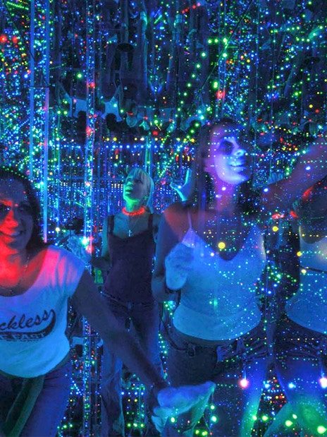 Visitors exploring the mirrored light maze at Infinity Attraction, Gold Coast.