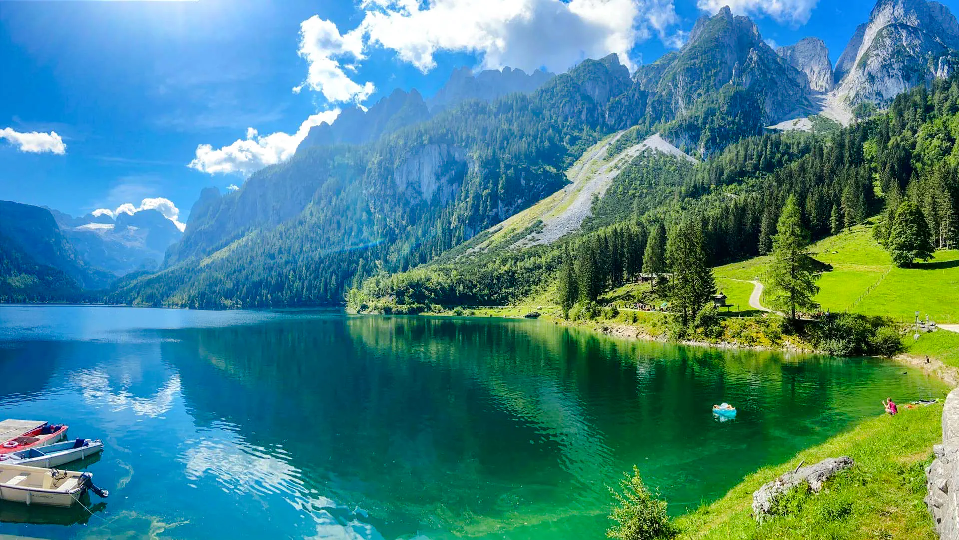 Alpine lake with mountains and forest, part of Hallstatt tour from Salzburg.