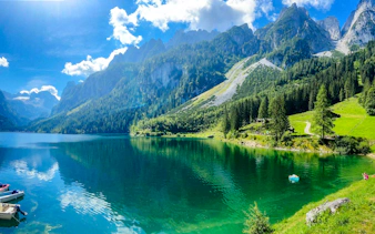 Alpine lake with mountains and forest, part of Hallstatt tour from Salzburg.
