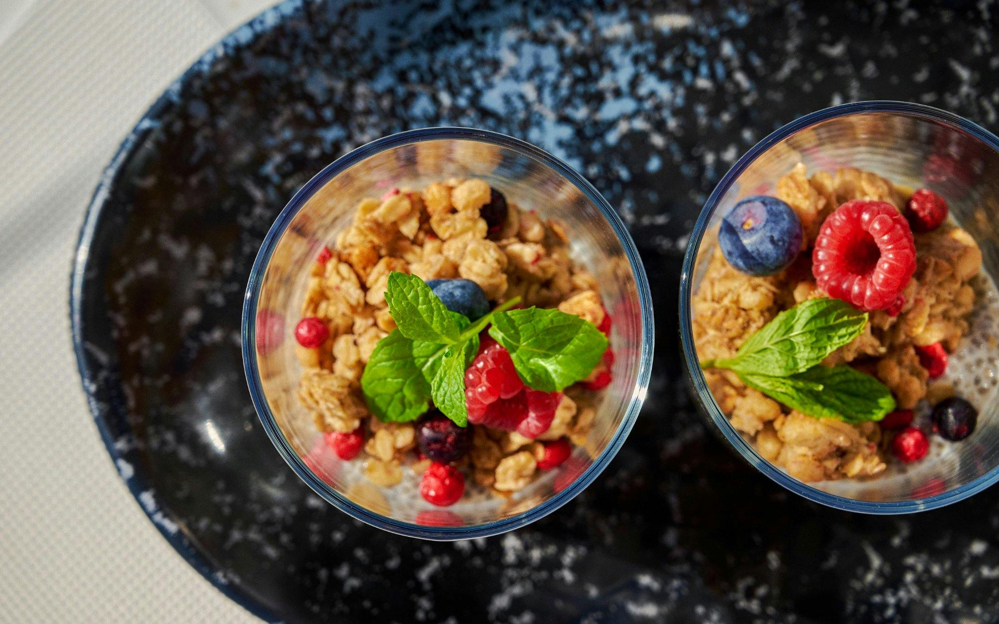 Granola parfaits with berries and mint served on a luxury catamaran cruise near Dia Island, Crete.