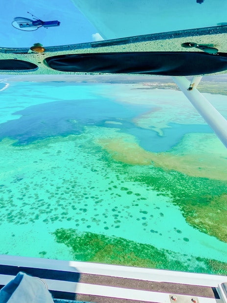 Aerial view of turquoise waters and coral reefs from a seaplane during the Scenic Seaplane Tour, Mauritius.