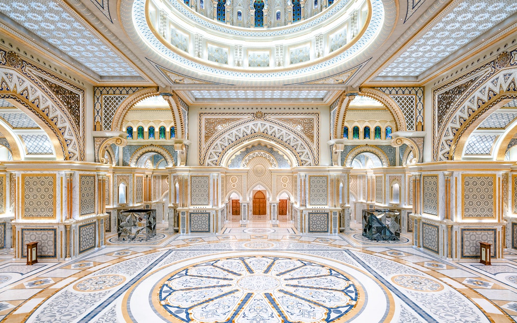 Ornate interior of Qasr al Watan in Abu Dhabi with intricate patterns and grand arches.