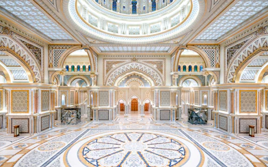 Ornate interior of Qasr al Watan in Abu Dhabi with intricate patterns and grand arches.