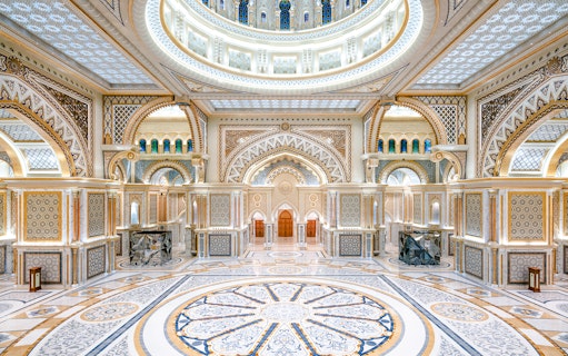 Ornate interior of Qasr al Watan in Abu Dhabi with intricate patterns and grand arches.