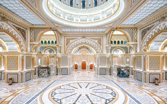 Ornate interior of Qasr al Watan in Abu Dhabi with intricate patterns and grand arches.