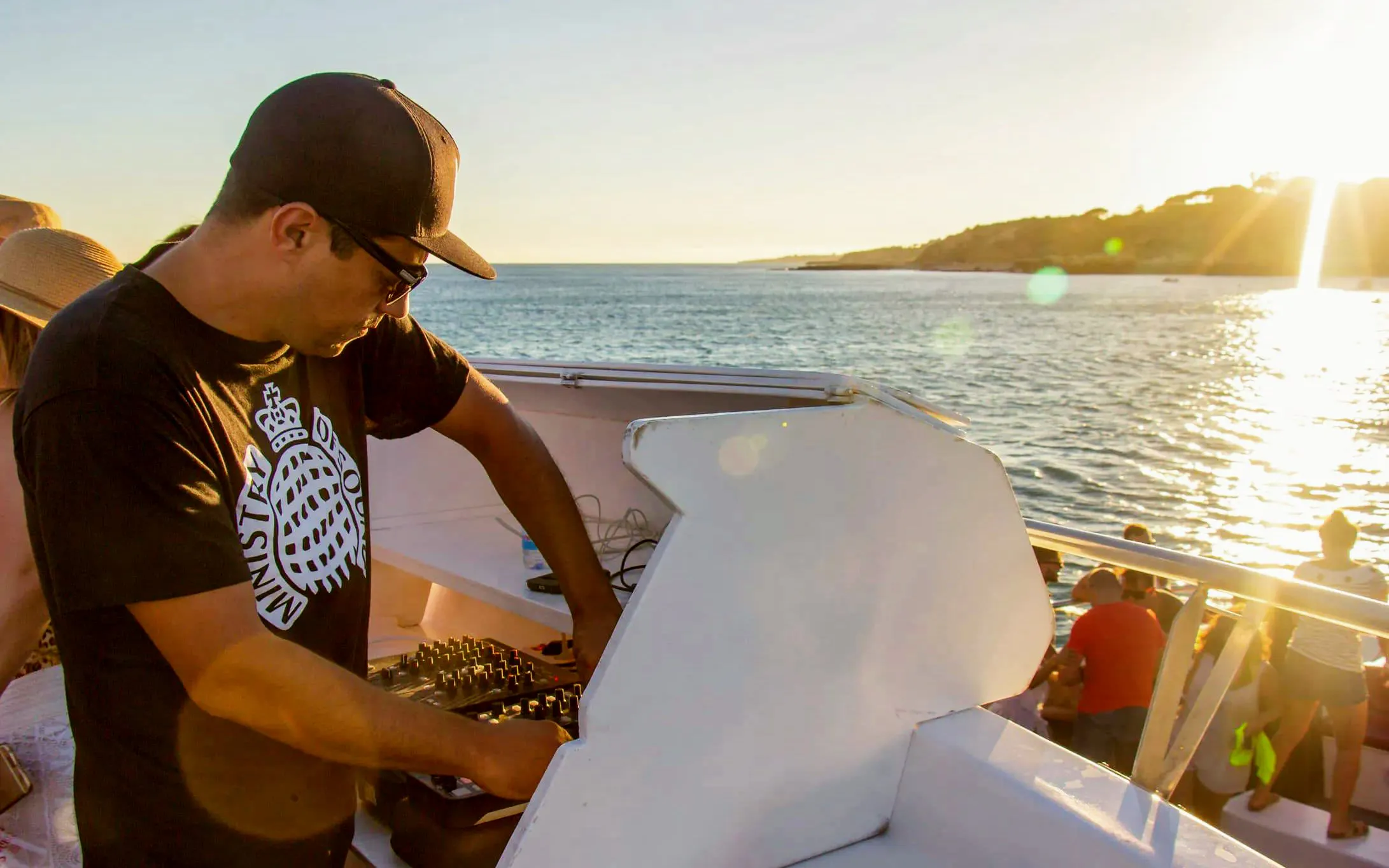 DJ performing on a boat during Albufeira sunset sailing tour in Algarve.