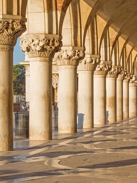 Doge's Palace arches with tourists using Venice Museum Pass for fast-track entry.