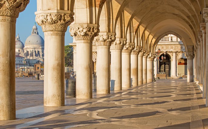 Doge's Palace arches with tourists using Venice Museum Pass for fast-track entry.