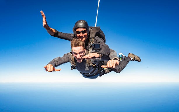 Tandem skydive over Shellharbour, Sydney at 15,000ft with clear blue sky.