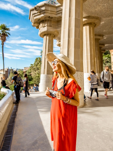 Barcelona Park Güell terrace with tourists and city view.