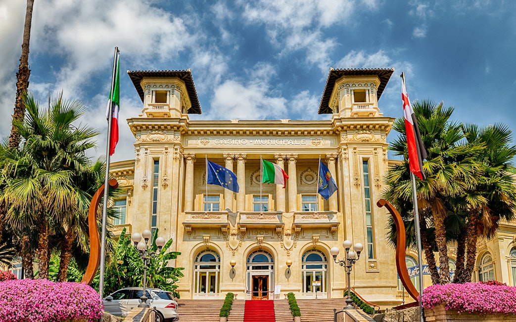 Casino Sanremo facade with flags, Italian Riviera tour.