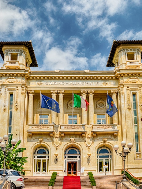 Casino Sanremo facade with flags, Italian Riviera tour.