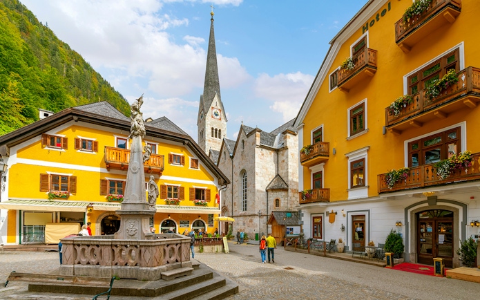 Market Square in Hallstatt with historic buildings and a central fountain.