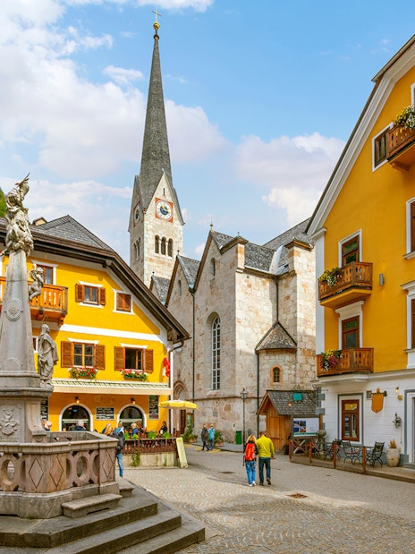 Market Square in Hallstatt with historic buildings and a central fountain.
