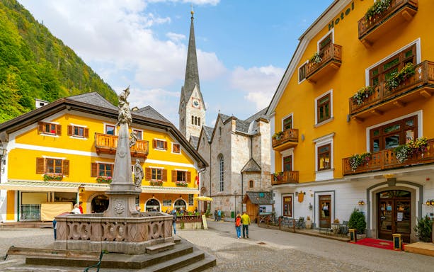 Market Square in Hallstatt with historic buildings and a central fountain.