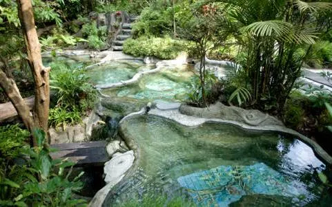 Krabi hot spring spa with natural rock pools surrounded by lush greenery.