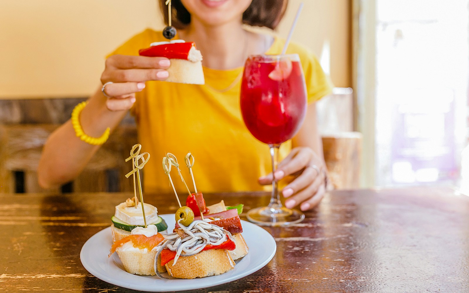 Sangria and assorted tapas on a table in a Spanish cafe.