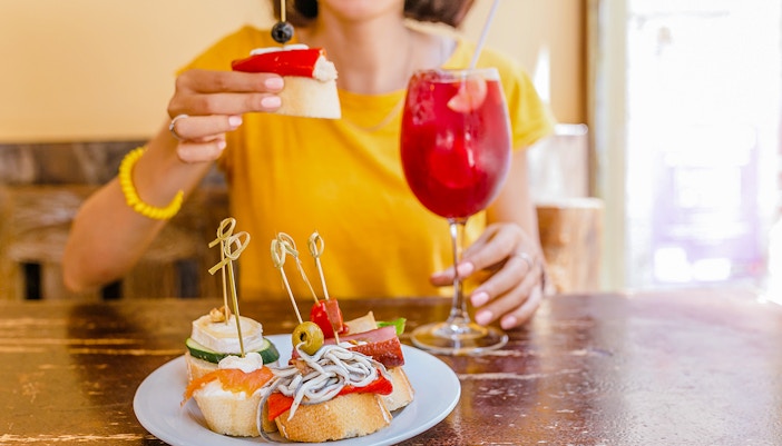 Sangria and assorted tapas on a table in a Spanish cafe.