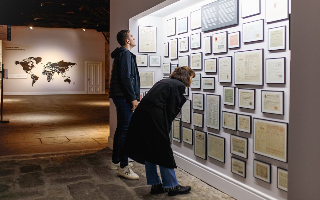 Visitors examining historical documents at Fonseca Port Wine Cellars in Portugal.