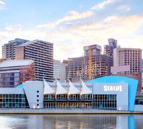 SEA LIFE Melbourne aquarium entrance with visitors exploring marine exhibits.