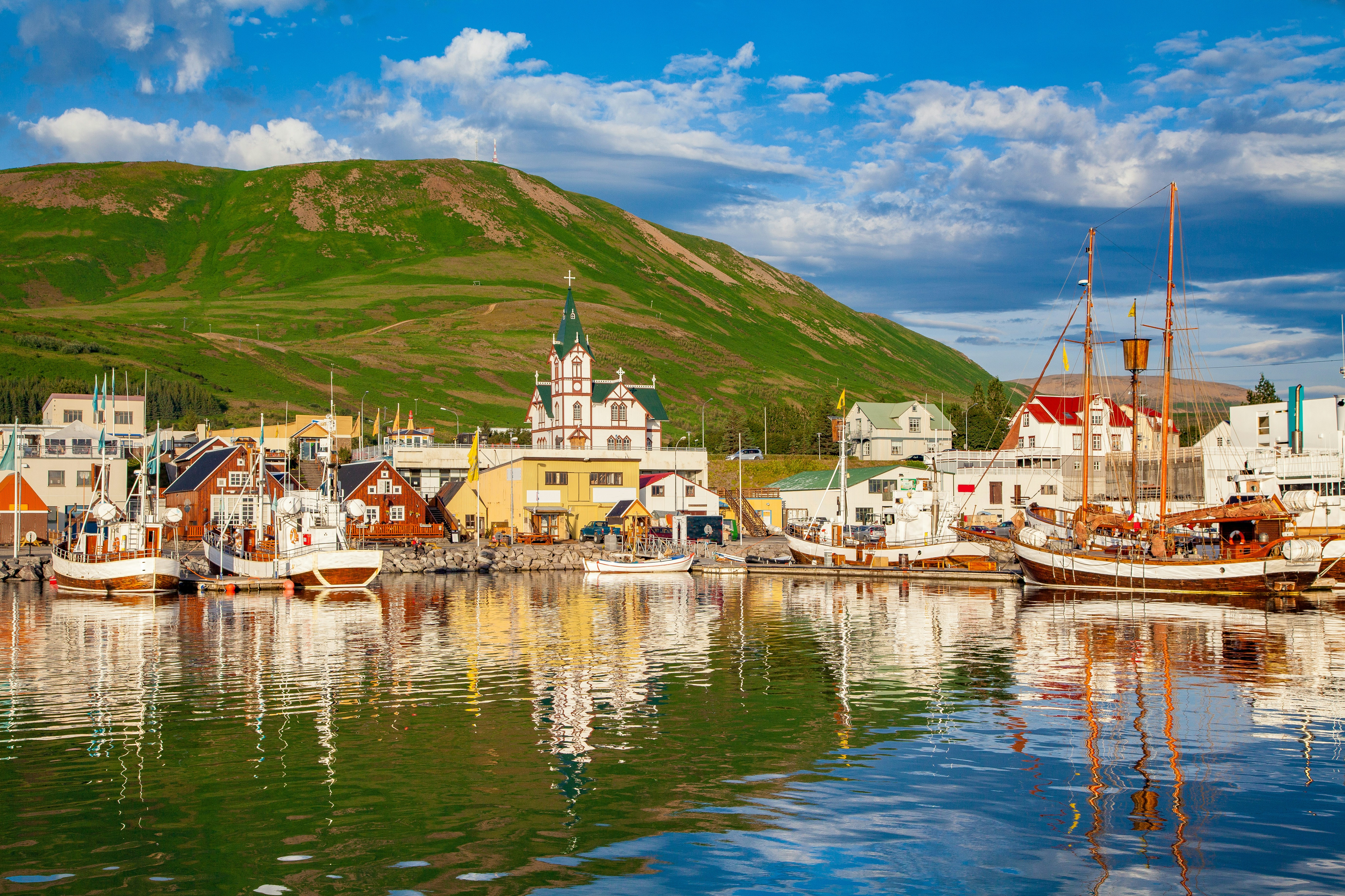 Husavik harbor with fishing boats at sunset, Iceland.