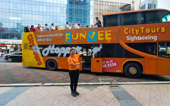 FunVee open-top bus with tourists in Singapore city tour.