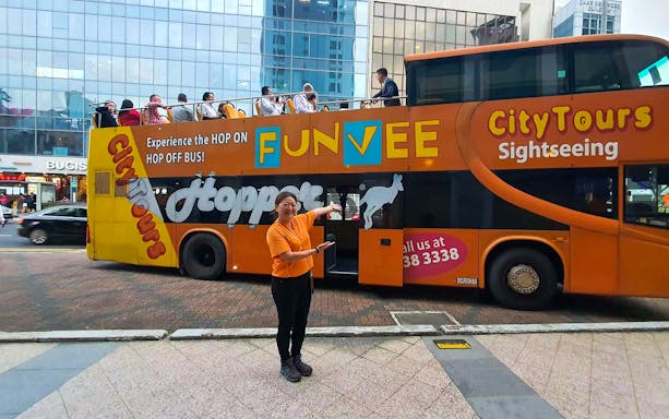 FunVee open-top bus with tourists in Singapore city tour.