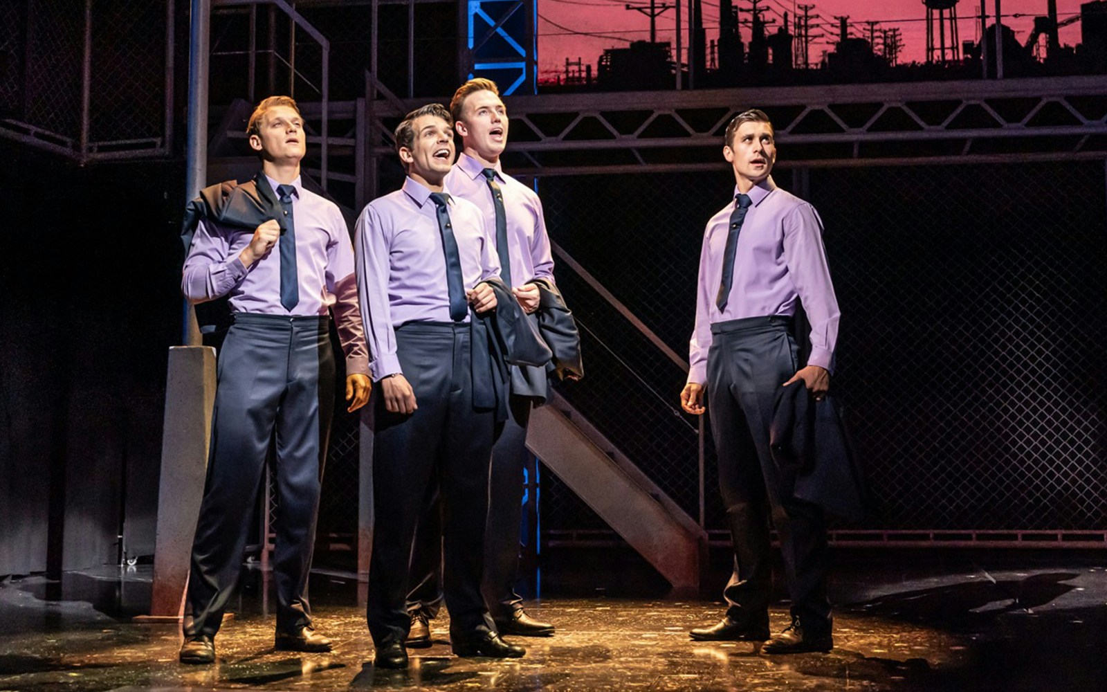 Performers on stage during a Jersey Boys musical scene.