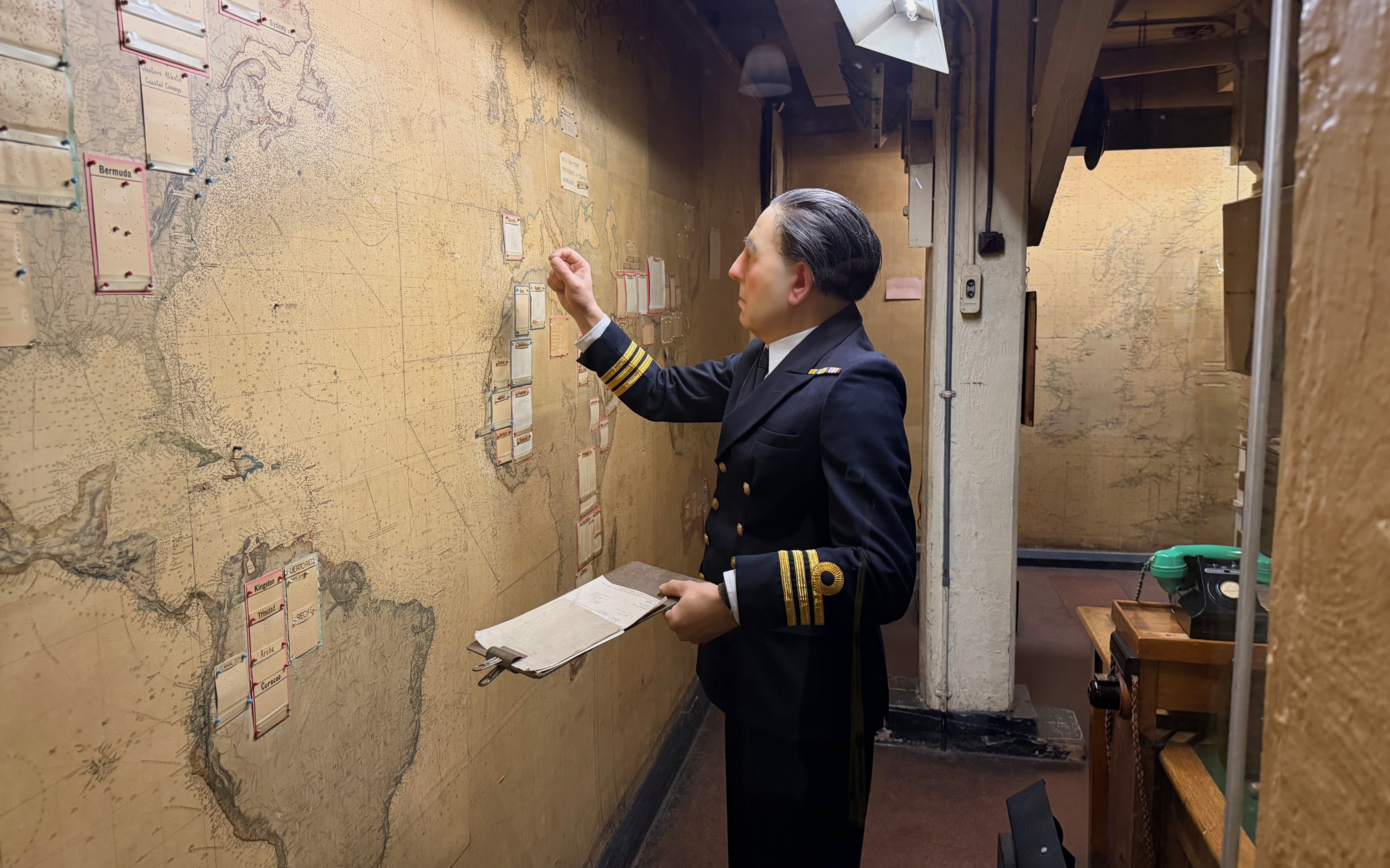 Officer examining map in Churchill War Rooms museum, London.