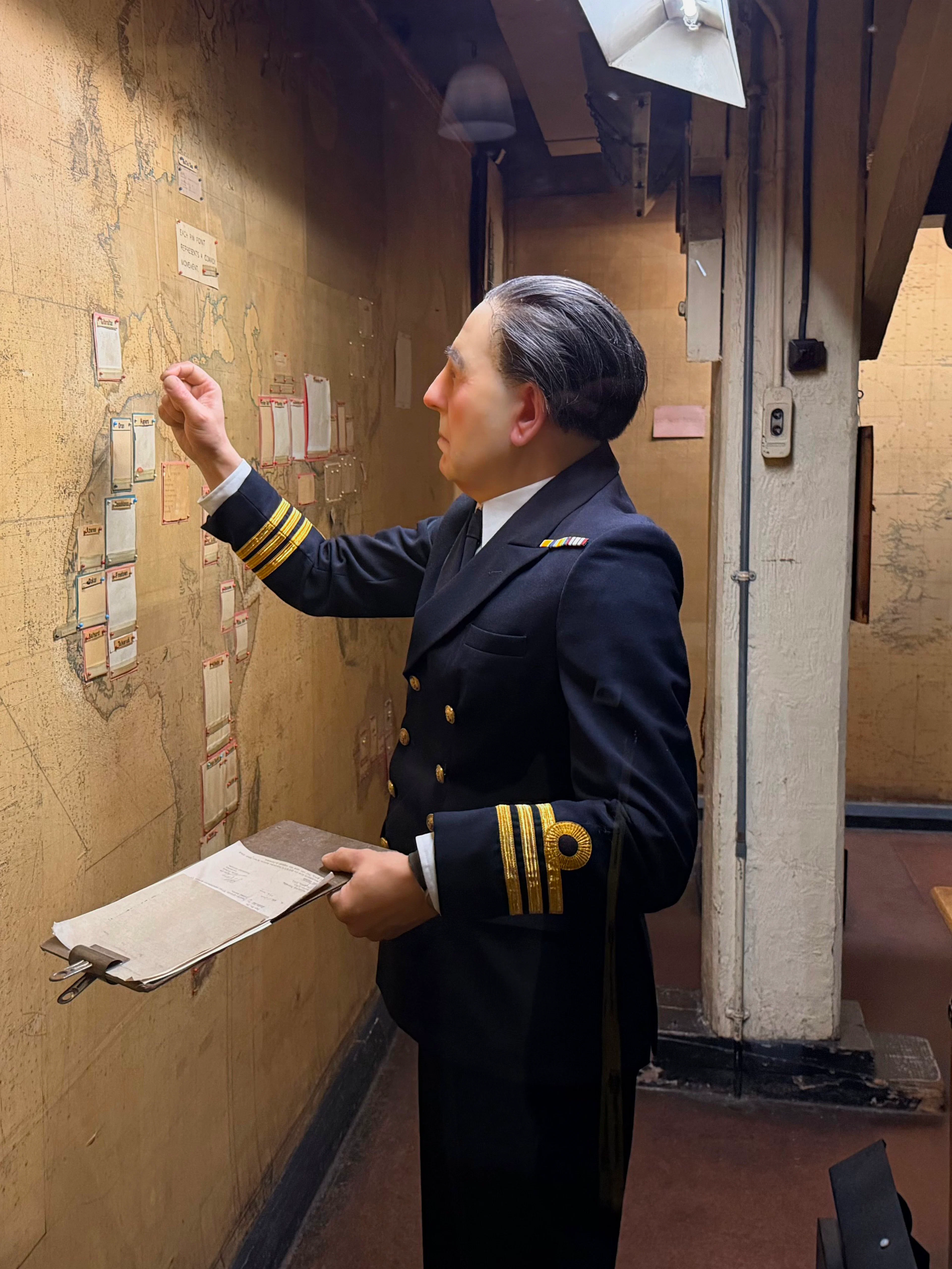Officer examining map in Churchill War Rooms museum, London.