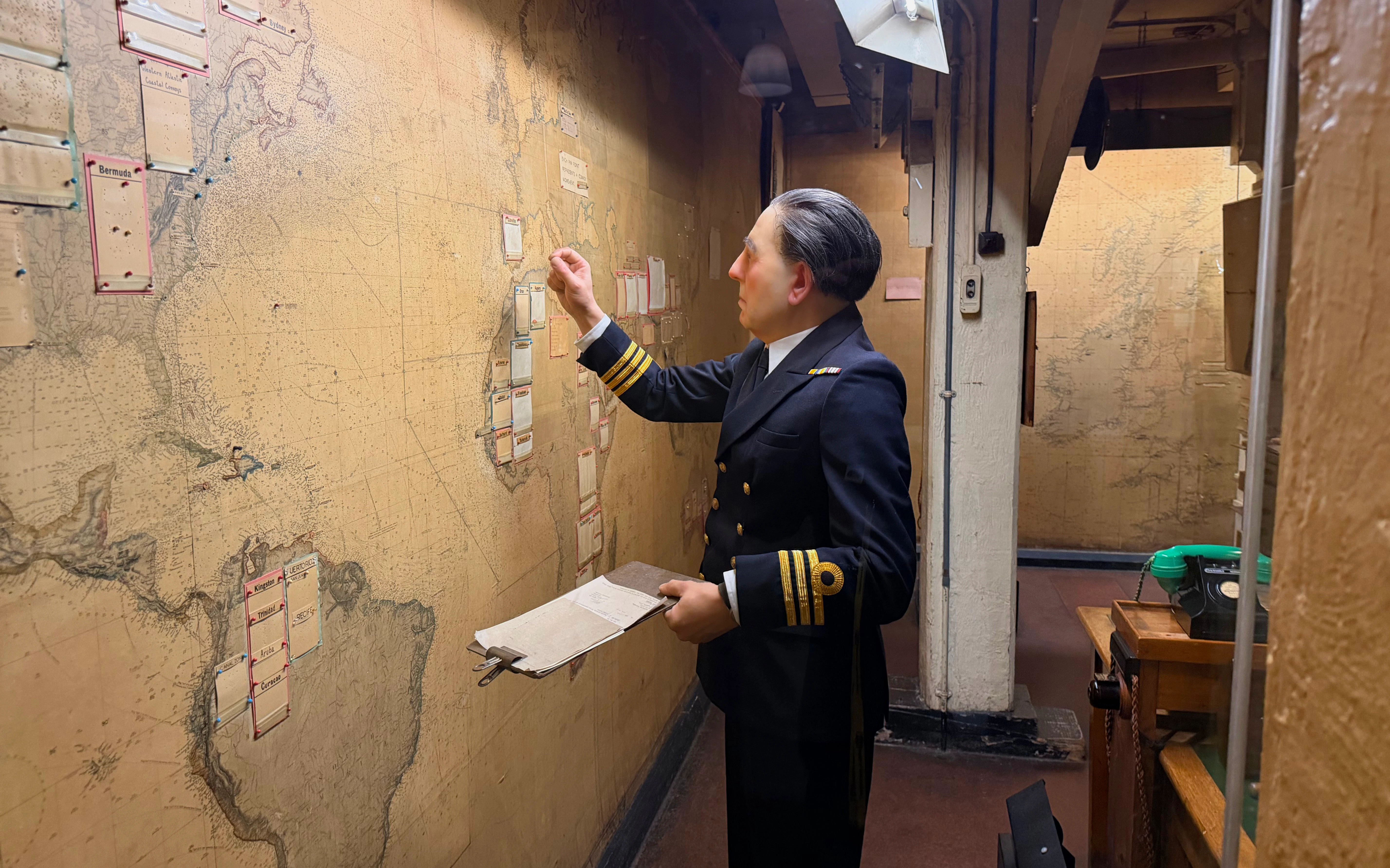 Officer examining map in Churchill War Rooms museum, London.