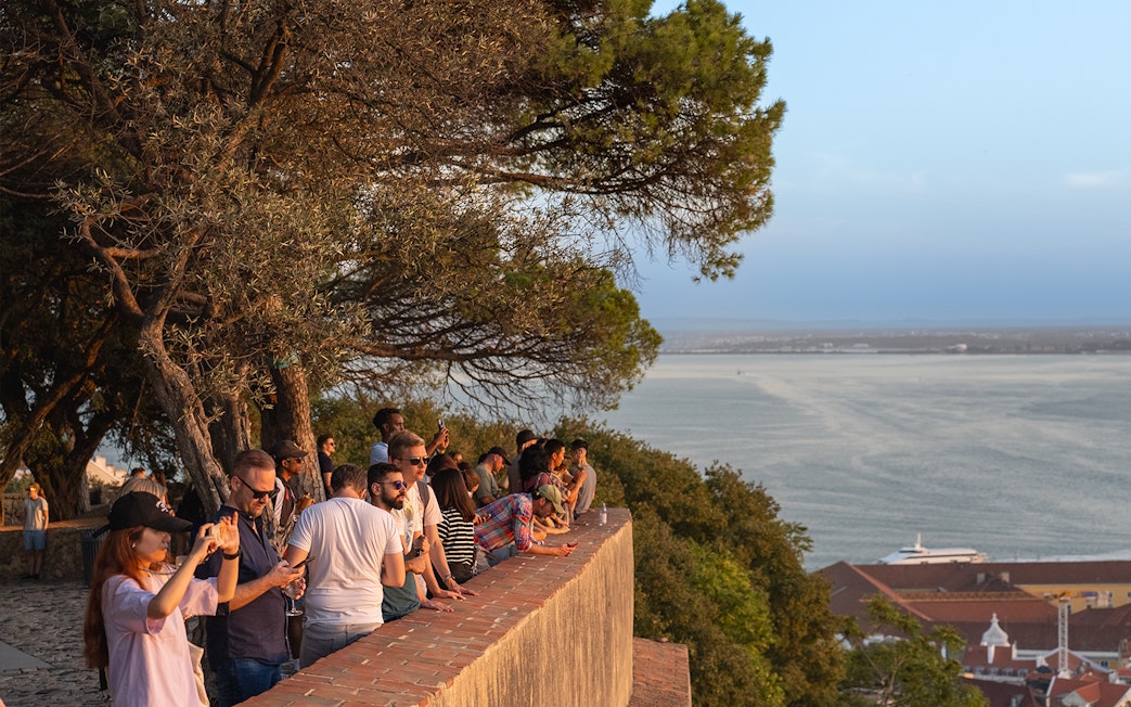 Visitors enjoying the view from St. George’s Castle overlooking Lisbon and the Tagus River.