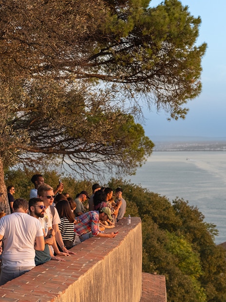 Visitors enjoying the view from St. George’s Castle overlooking Lisbon and the Tagus River.