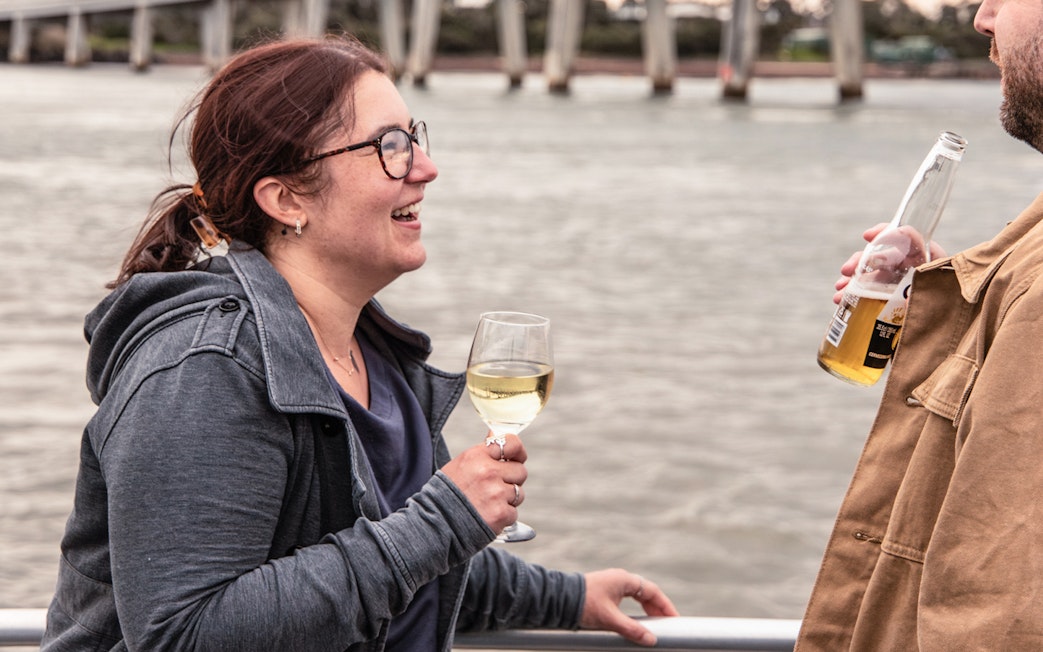 People enjoying drinks on a boat during a sunset sightseeing cruise at Phillip Island.