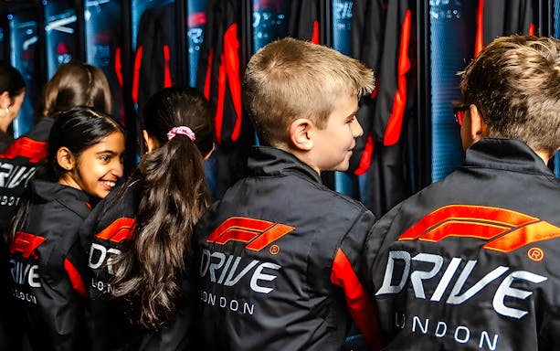 Kids preparing for F1 London Mixed session in racing gear.
