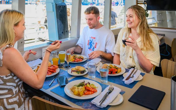 People enjoying lunch on a Swan River cruise in Perth.