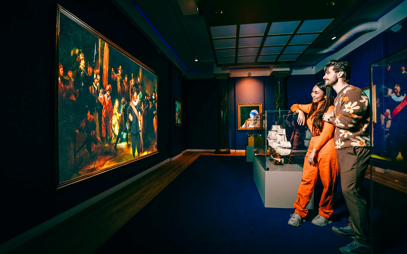 Guests viewing art and ship model at a museum in Holland.