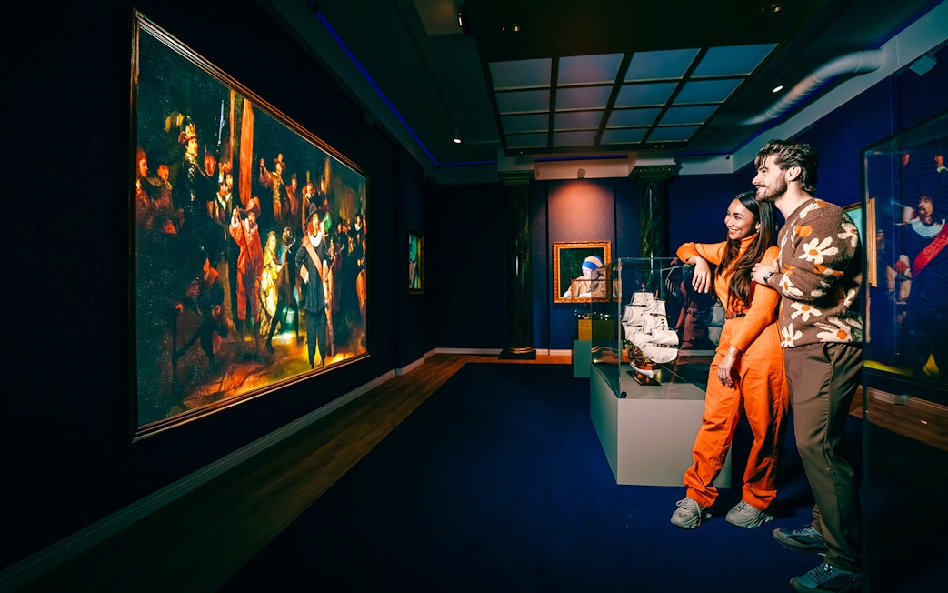 Guests viewing art and ship model at a museum in Holland.