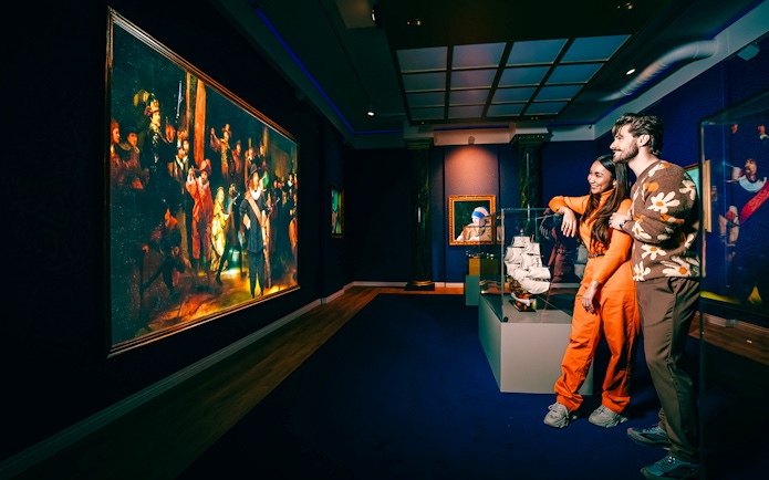 Guests viewing art and ship model at a museum in Holland.