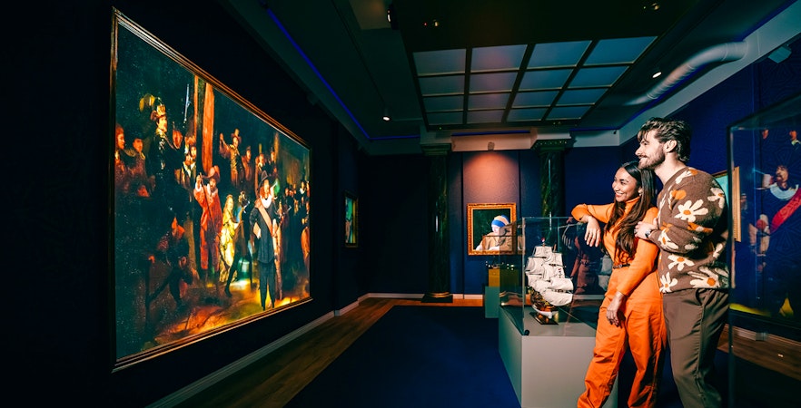 Guests viewing art and ship model at a museum in Holland.