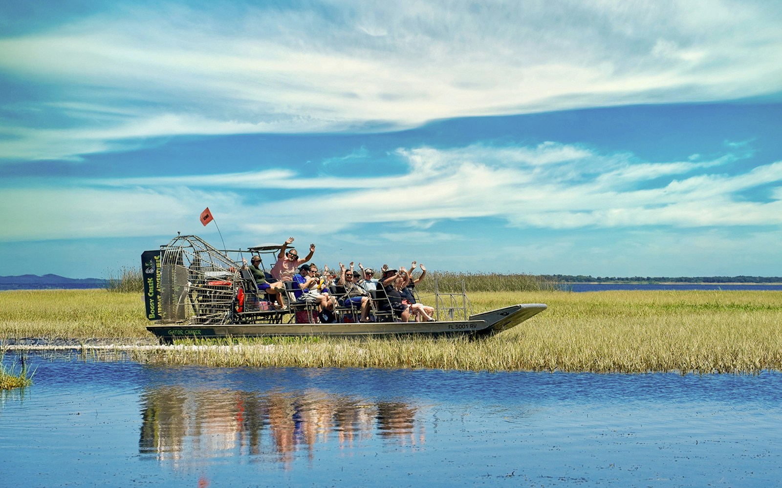 Guests on an airboat tour at Boggy Creek, enjoying the scenic wetlands.