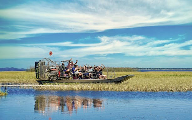 Guests on an airboat tour at Boggy Creek, enjoying the scenic wetlands.