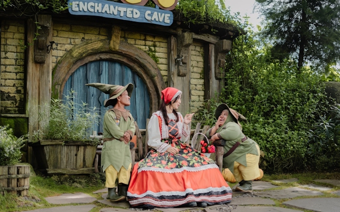 Characters in fairy tale costumes outside Enchanted Cave at Dairyland Farm Theme Park Puncak.